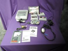 A Nintendo Super Nintendo Entertainment System with two controllers, power supply and four games,