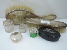 A small selection of HM silver dressing table items including silver backed brushes, glass