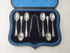 A cased set of six silver teaspoons with matching sugar nips all having brightcut decoration to