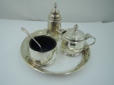 A silver three piece cruet set having facetted decoration and blue glass liners, Birmingham 1961,