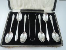 A cased set of six silver teaspoons with matching sugar nips having decorative rims, Birmingham