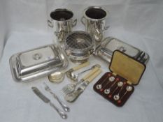 A selection of silver plate including bottle holders, rose bowl, lided tureens, cased tea spoons