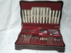 A canteen of silver cutlery (54 & 9) retailed by Reid & Sons of Newcastle in the plain pine