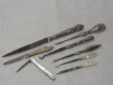 A small selection of HM silver and mother of pearl items including button hooks, manicure tools,