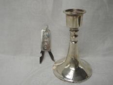 A silver candle stick having a weighted circular splayed base, Birmingham 1933, makers mark worn,