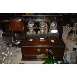 A mid century tantalus with a set of Stuart decanters and two HM silver name tage one for port and