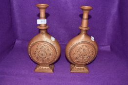 Two terracotta moon flasks/vases having cut out and embossed detailing.