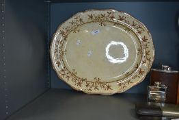 A large antique meat platter having brown floral transfer pattern to cream ground,Jessamine T,W