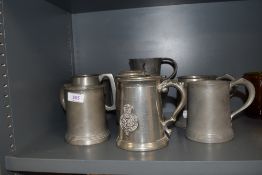 A collection of pewter tankards and vessels.