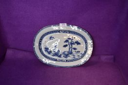 An antique meat or similar charger plate Chinese export hard paste with hand decorated fantasy scene