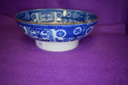 An antique footed fruit or water bowl having traditional blue and white design and tin glaze