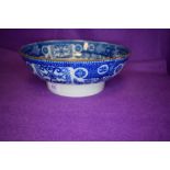 An antique footed fruit or water bowl having traditional blue and white design and tin glaze