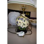 A Moorcroft Hepatica table lamp having cream and blue ground with lilac flowers.