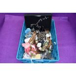 A basket of costume jewellery including bracelets, brooches, rosary beads etc