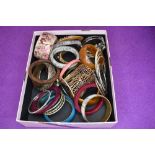 A large selection of costume jewellery bangles including, wood, plastic, metal etc