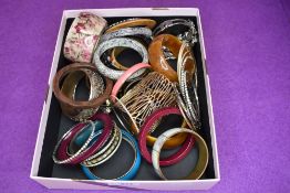A large selection of costume jewellery bangles including, wood, plastic, metal etc