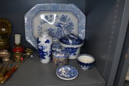 A variety of blue and white ceramics including platter,vase and lidded bowl.
