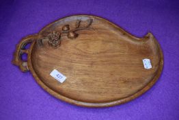 an arts and crafts style cheese board with naturalistic design 34cm long approx