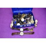 A cash tin containing a selection of costume jewellery wrist watches including Swatch, Rotary,