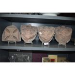 A selection of carved sandstone corbels or gargoyle face masks having been removed from local