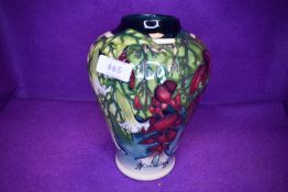 A large Moorcroft vase of baluster form having cream, green and blue ground with floral pattern in