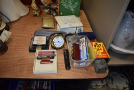A mixture of items including vintage travel clock, picture frames and writing accessories.