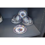 A collection of Wedgwood coffee cups and saucers having floral pattern and blue banding, marked
