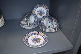 A collection of Wedgwood coffee cups and saucers having floral pattern and blue banding, marked