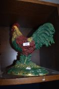 A large cast cockerel door stop.