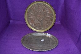 A large copper and brass tazza or platter(AF) in the Elkington manner, having embossed Nouveau style