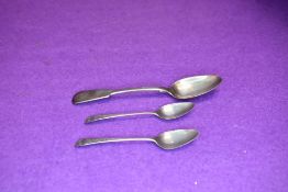 Two Georgian silver teaspoons having engraved floral decoration and a Victorian silver dessert spoon
