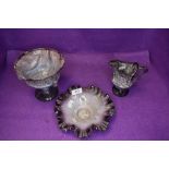 Three pieces of marbled art glass in purple and white hues