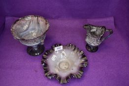 Three pieces of marbled art glass in purple and white hues