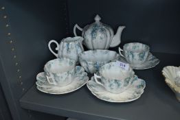 A collection of German tea ware with scalloped edges including tea pot, cups and saucers, bowl and