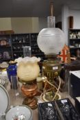 Two vintage oil lamps having been converted to electric and spare chimney.