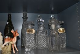 Seven vintage decanters, various styles and sizes.