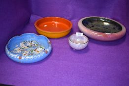 A selection of ceramic dishes including Byzanta ware and delft style