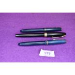 Two Parker Slimfold fountaiin pens in blue with single decorative band to cap, and a Sheaffer in