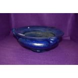 An antique art nouveau iridescent mottled blue bowl having triple handle and footed base 29cm across