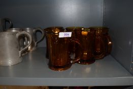 Six retro amber coloured glass mugs.