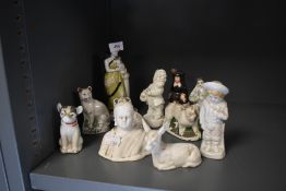 A selection of Staffordshire style figurines including animals and children.