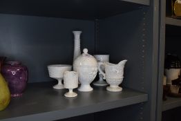 A collection of vintage milk glass, including vases and jugs.