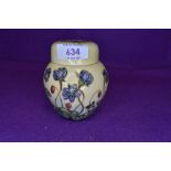 A Moorcroft Hepatica design ginger jar having lilac floral pattern to cream ground.
