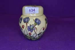 A Moorcroft Hepatica design ginger jar having lilac floral pattern to cream ground.