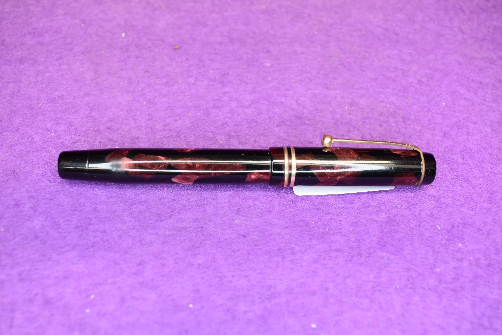 A Parker Duofold in red marble with two gold bands to cap slight wear to clip