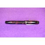 A Parker Duofold in red marble with two gold bands to cap slight wear to clip