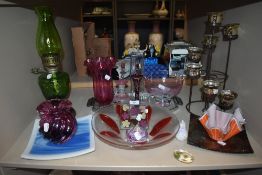 A selection of vintage and modern art glass including plates, bowls and vases.