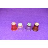 A selection of four fine and detailed miniature glass makers thimbles having various designs