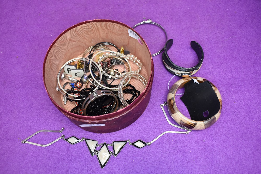 A tub of costume jewellery bracelets and bangles
