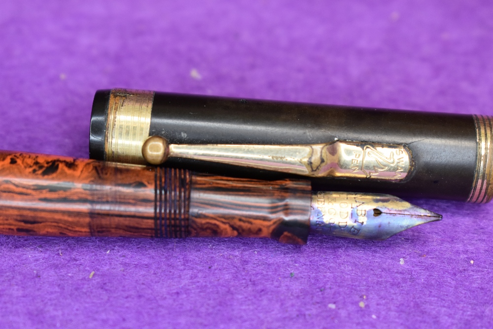 A Mabie Todd Swam leverfill fountain pen with an orange and black patern, the cap top has the same - Image 2 of 2